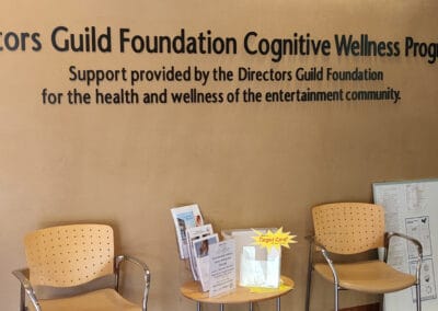Chairs underneath a sign that says "Directors Build Foundation Cognitive Wellness Program"