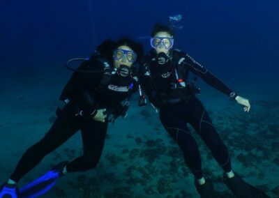 Two scuba divers posing for a photo.