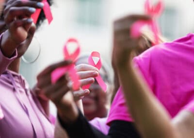 Breast Cancer Awareness Ribbons In Women’s Hands Breast Cancer Awareness Ribbons In Women's Hands